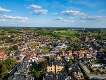 High angle view of townscape by sea against sky