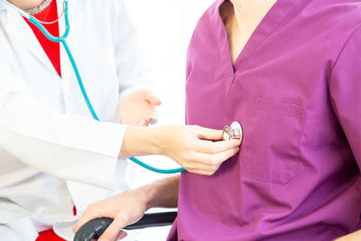 Midsection of couple holding hands