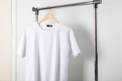 Clothes hanging on rack against wall