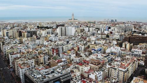 High angle view of modern buildings in city against sky