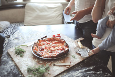 Pizza on the family table, lifestyle in a real interior, toning