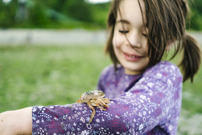 Closeup image of a shore crab on a child's arm