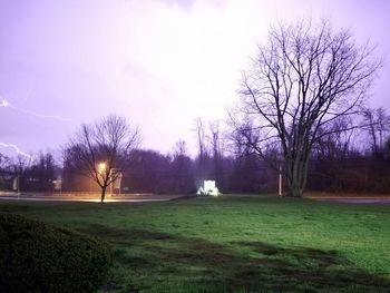 Scenic view of grassy field against sky