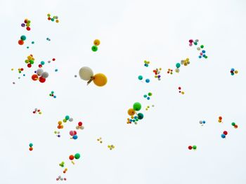 High angle view of multi colored balloons against white background