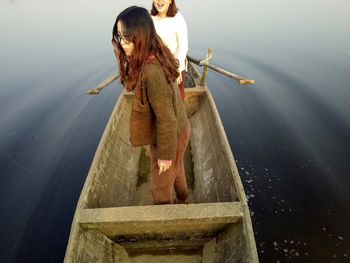 Rear view of woman on boat in lake