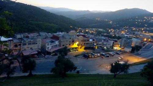 High angle view of illuminated street amidst buildings in city