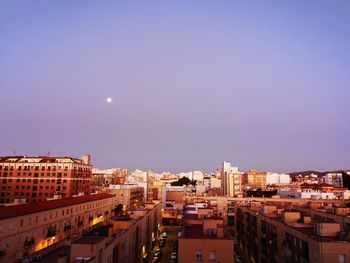 High angle view of illuminated buildings against clear sky at night