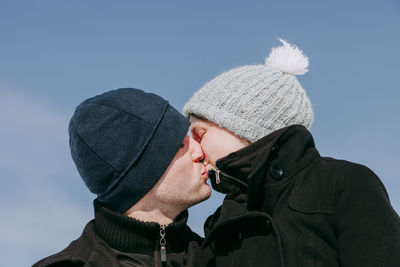 Couple kissing sky during winter