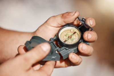 Cropped hand holding navigational compass