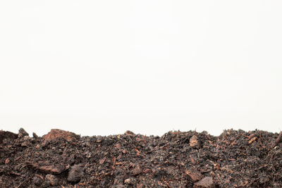 Rock formations on landscape against clear sky