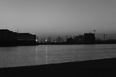 View of river in city at dusk