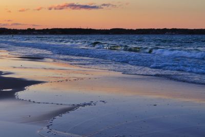 Scenic view of beach against sky during sunset