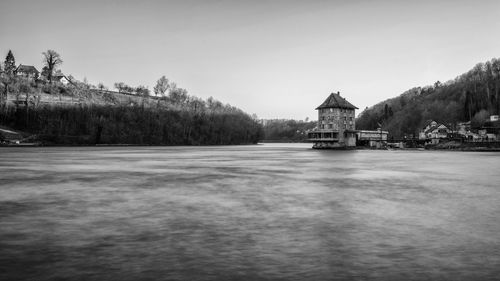 Lake and buildings against sky