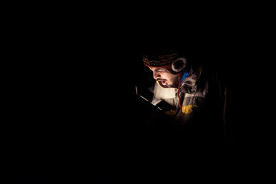 Man using phone in darkroom