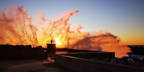 Smoke emitting from chimney against sky during sunset