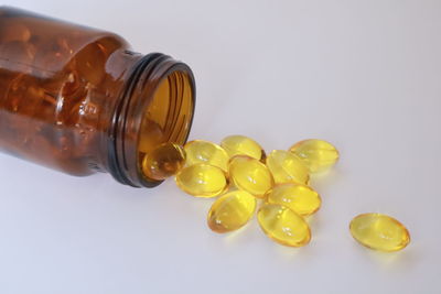Close-up of yellow bottle against white background