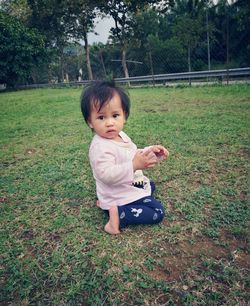 Portrait of cute baby girl on grass