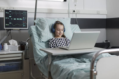 Portrait of woman using laptop at home