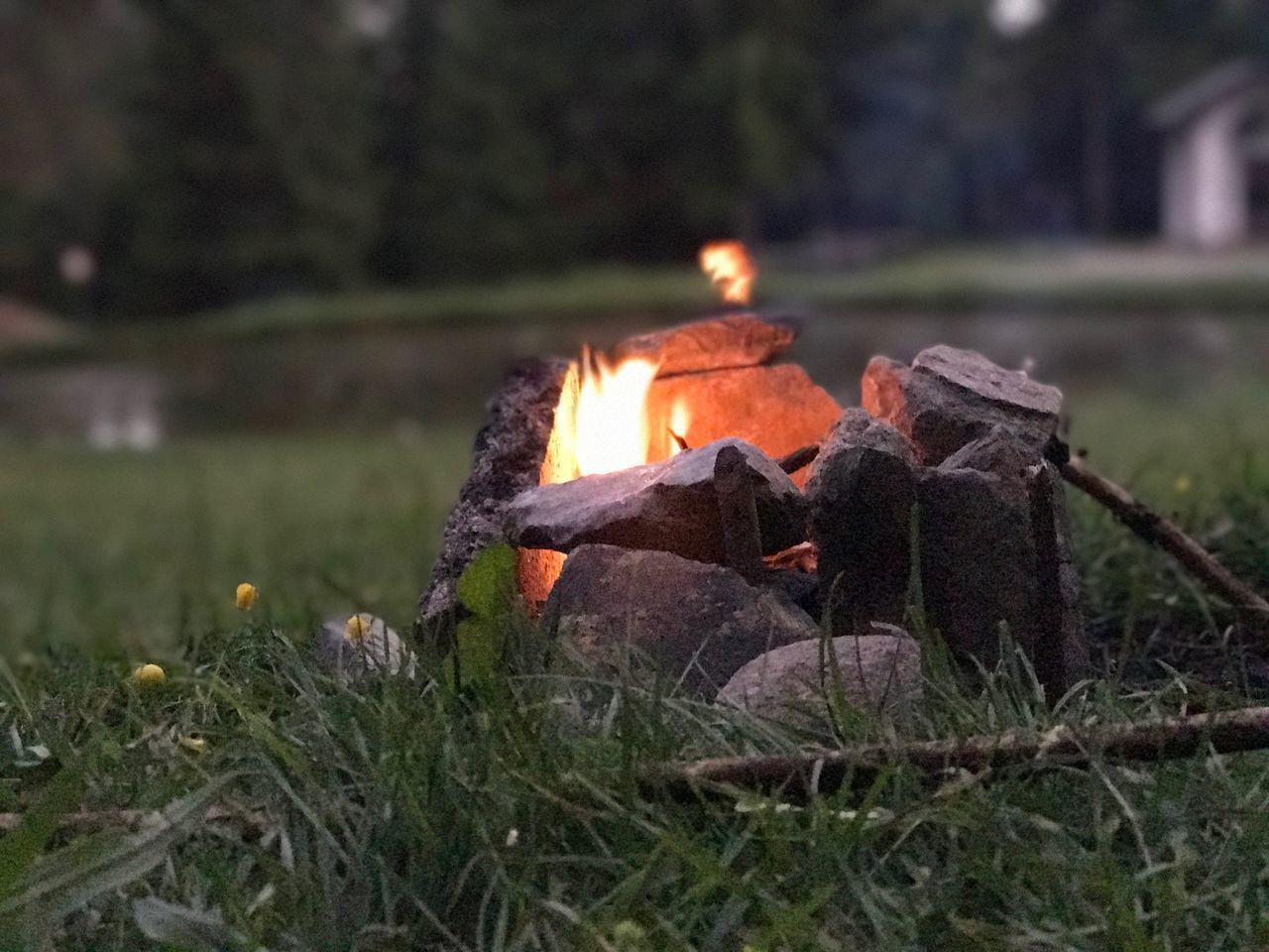 CLOSE-UP OF BONFIRE ON FIELD AT NIGHT