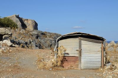 Old ruin on field against sky