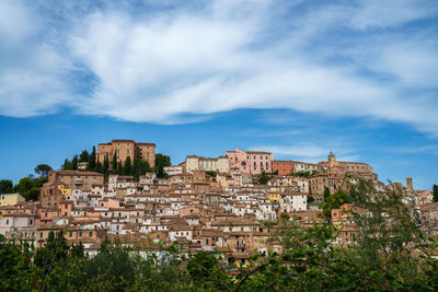 Buildings in city against sky