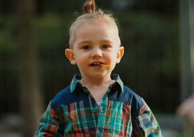 Portrait of cute boy standing outdoors