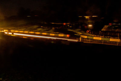 Light trails on road in city at night