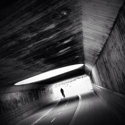 Woman walking in tunnel