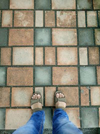 Low section of man standing on footpath