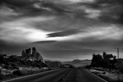 View of highway against cloudy sky