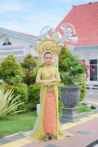 Portrait of woman standing by fountain