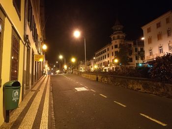 Illuminated city street at night