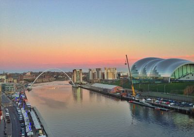 View of bridge over city at sunset