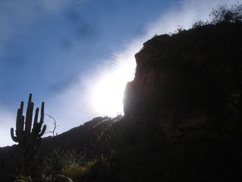 Low angle view of mountain against cloudy sky