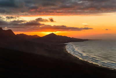 Scenic view of sea against sky during sunset at fuerteventura. jandia hills and cofete