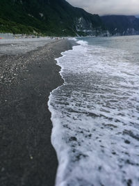 Scenic view of sea against mountain