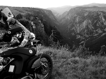 Close-up of motorcycle on landscape