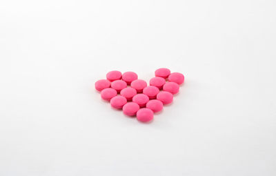 Close-up of pink heart shape over white background