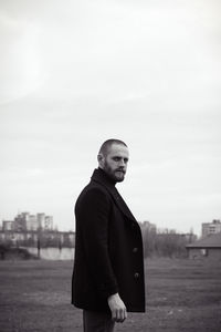 Portrait of man while standing against sky