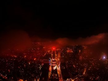 High angle view of city lit up at night