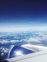 Aerial view of clouds over landscape seen from airplane