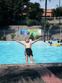 Full length of shirtless man in swimming pool