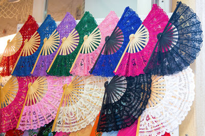 Close-up of multi colored hand fan for sale in market