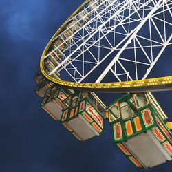 Low angle view of ferris wheel against sky