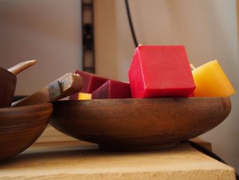 Candle cubes in wooden bowl on table