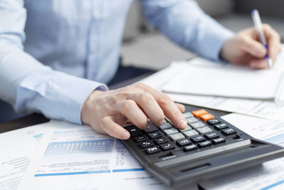 Midsection of businessman working at office