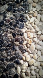 Full frame shot of pebbles on sand