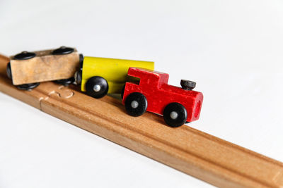 Close-up of toys on table against white background