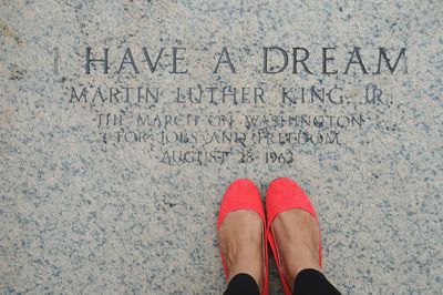 Low section of woman standing on wall