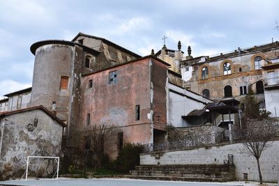 Low angle view of abandoned building against sky